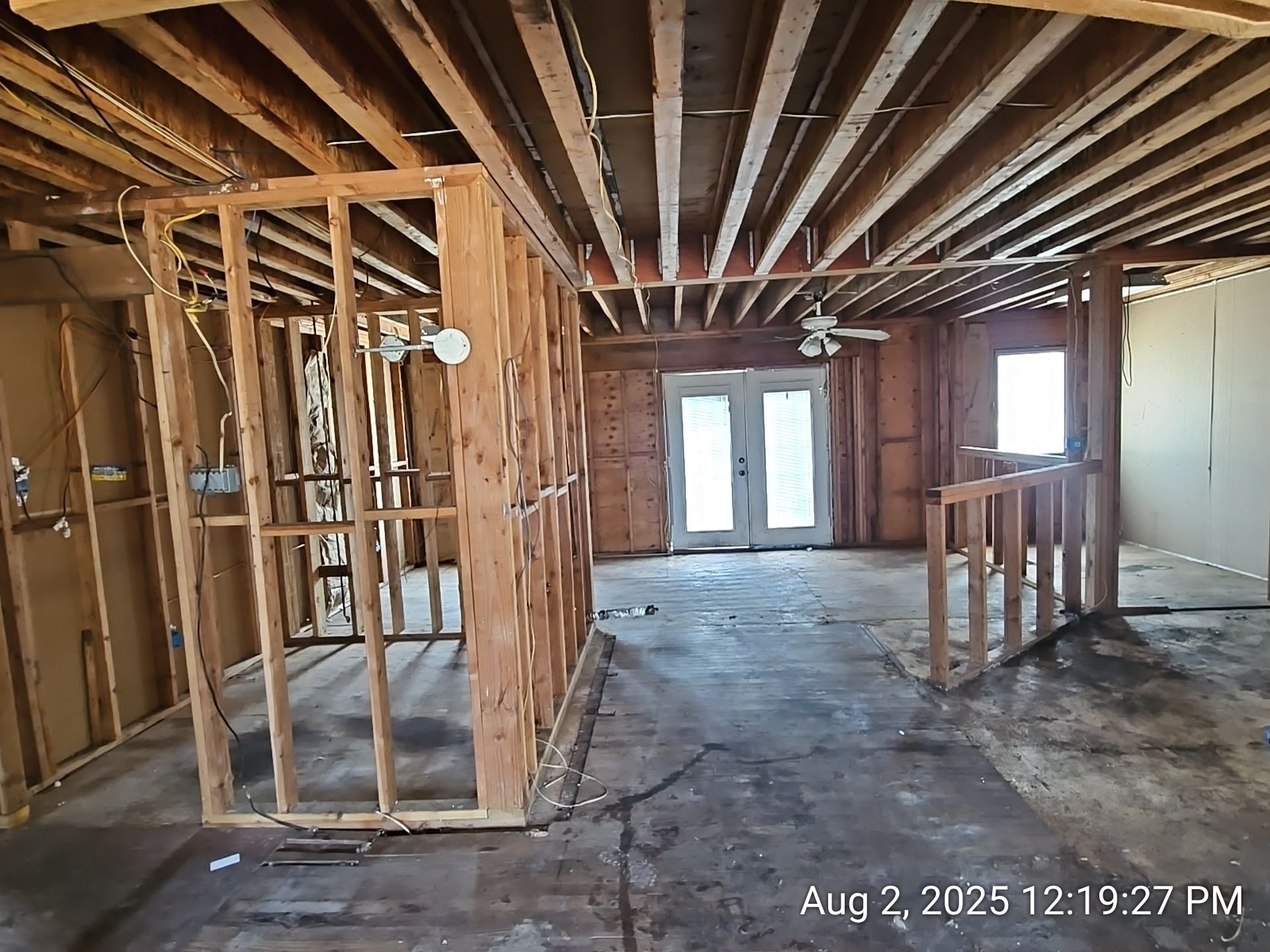 Stripped residential interior with exposed framing documented during an assessment