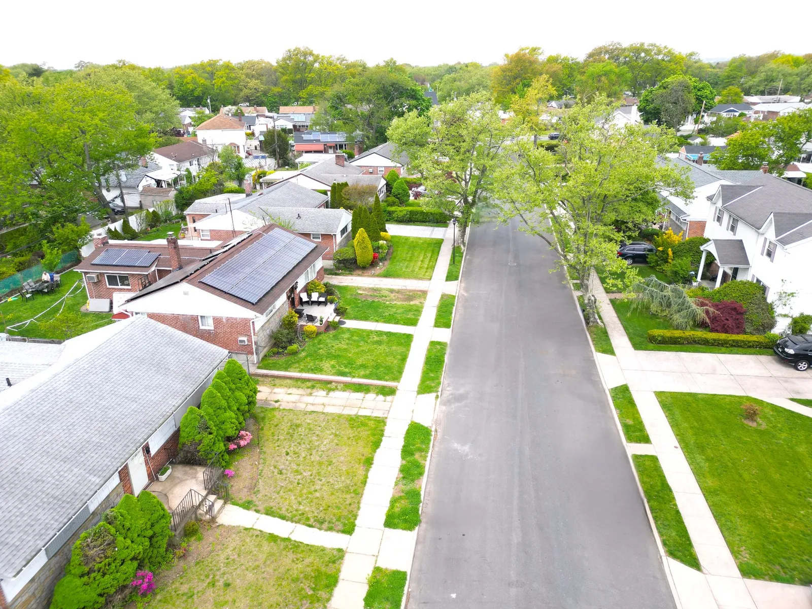 Aerial view of a Queens residential street with well-kept homes